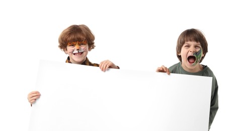 Photo of Cute boys with colorful face paintings and blank banner on white background. Space for text