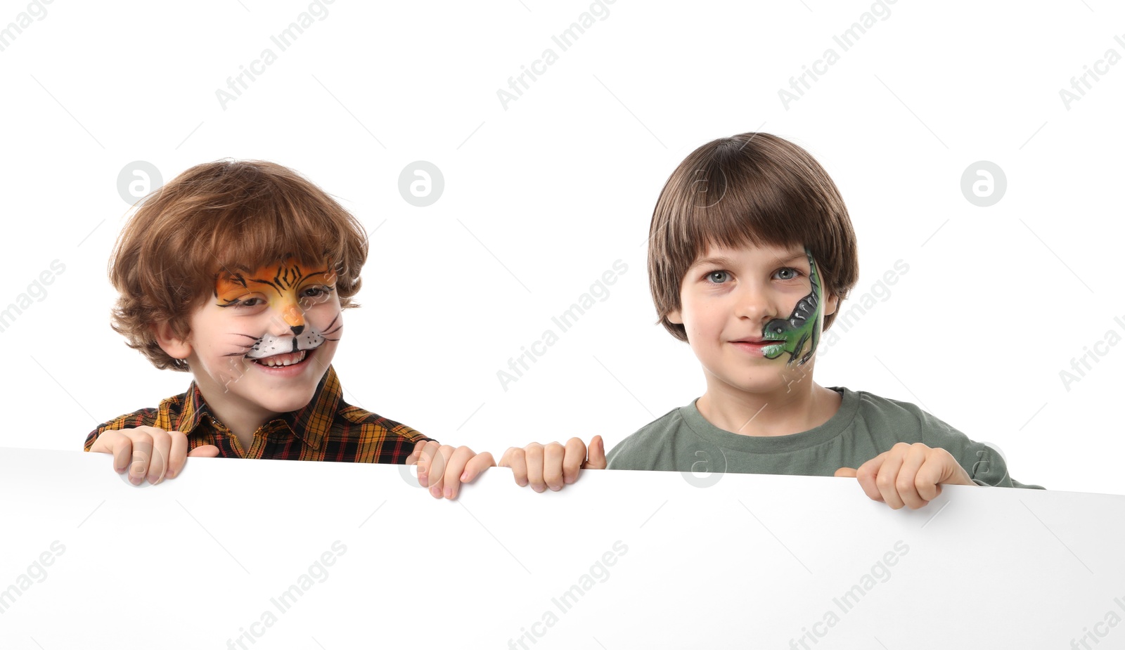 Photo of Cute boys with colorful face paintings and blank banner on white background. Space for text