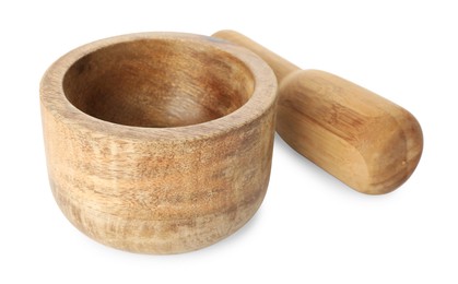 Photo of Wooden mortar with pestle isolated on white
