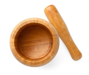 Photo of Wooden mortar with pestle isolated on white, top view