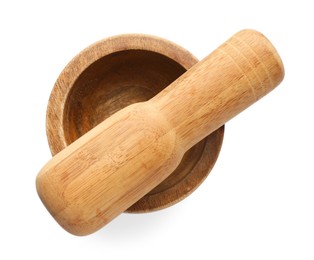Photo of Wooden mortar with pestle isolated on white, top view