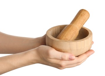 Photo of Woman with mortar and pestle on light background, closeup
