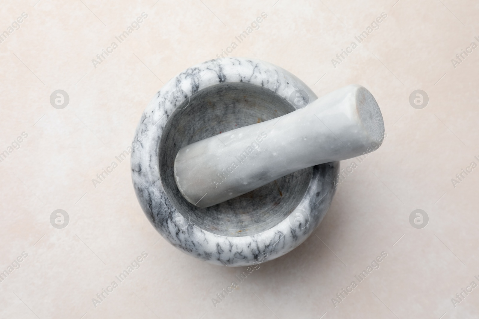 Marble mortar and pestle on white table, top view Photo of Marble mortar and pestle on white table, top view