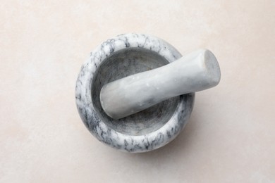 Photo of Marble mortar and pestle on white table, top view