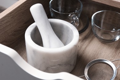 Photo of Marble mortar and pestle in drawer indoors, closeup