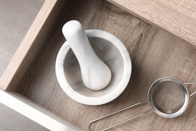 Photo of Marble mortar and pestle in drawer indoors, top view