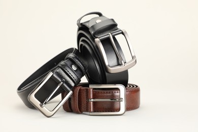 Photo of Three color leather belts on white background, space for text