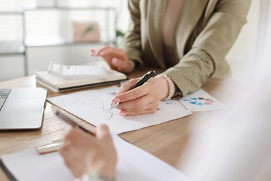 Photo of Woman having meeting with banker at desk in office, closeup