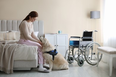 Photo of Woman with disability and her service dog at home