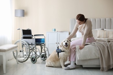 Photo of Woman with disability and her service dog at home