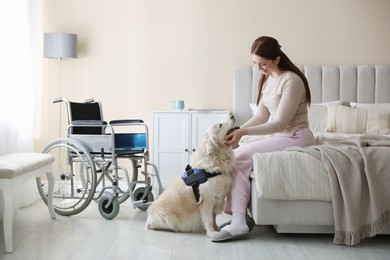 Photo of Woman with disability and her service dog at home