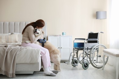 Photo of Woman with disability hugging her service dog at home