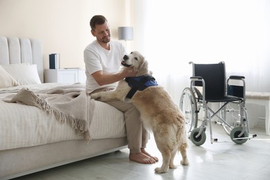 Photo of Man with disability and his service dog at home