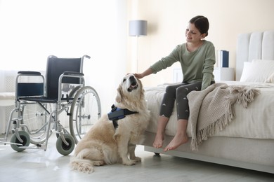Photo of Girl with disability and her service dog at home