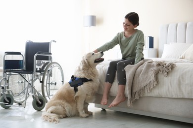 Photo of Girl with disability and her service dog at home