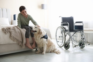 Photo of Girl with disability and her service dog at home