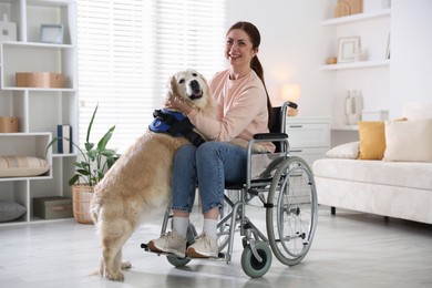 Photo of Woman in wheelchair hugging her service dog at home