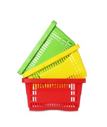 Photo of Stack of colorful shopping baskets isolated on white