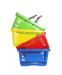 Photo of Stack of colorful shopping baskets isolated on white