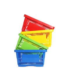Photo of Stack of colorful shopping baskets isolated on white