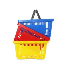 Photo of Stack of colorful shopping baskets isolated on white