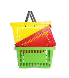Photo of Stack of colorful shopping baskets isolated on white