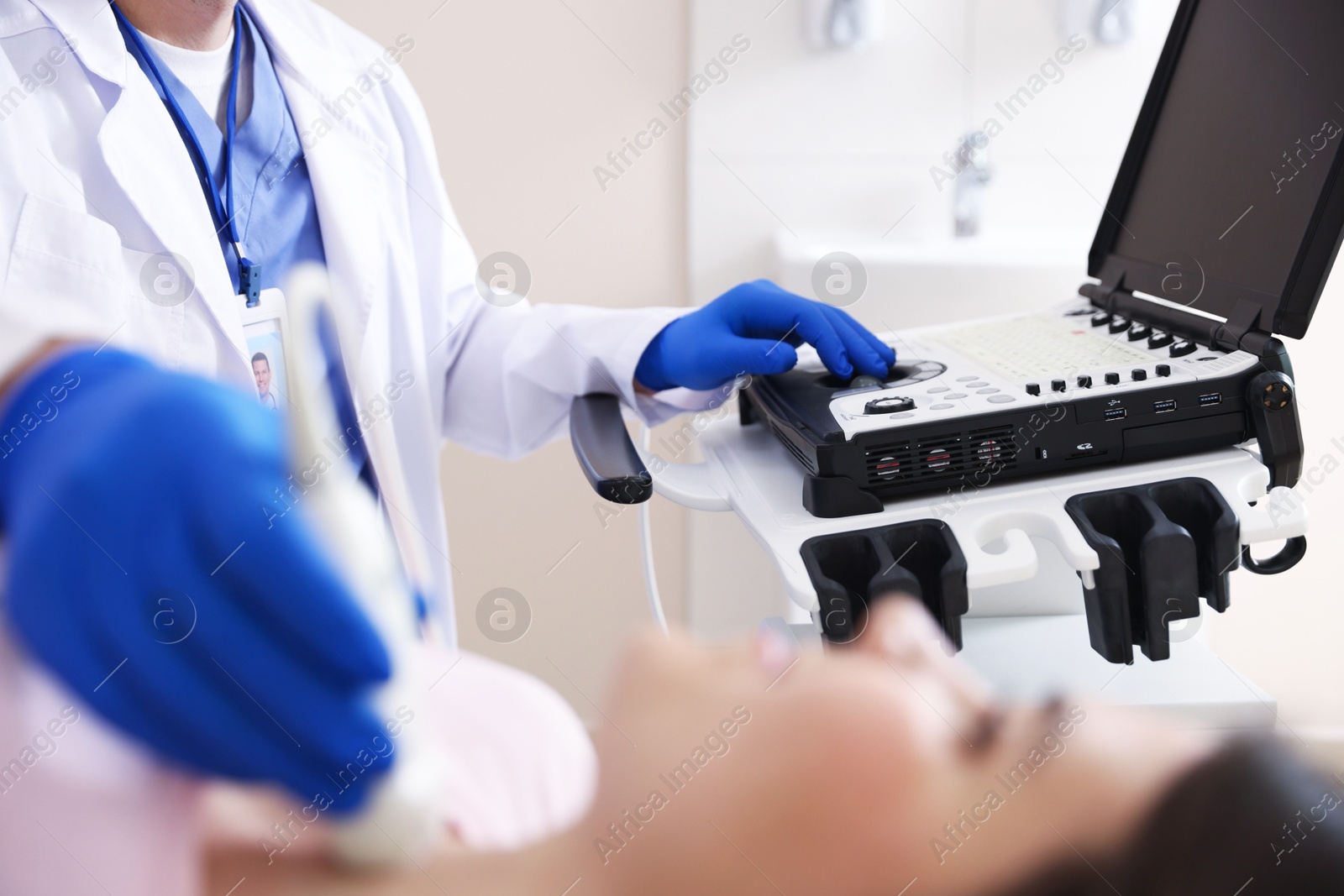 Sonographer conducting ultrasound examination of woman's thyroid gland in clinic, selective focus Photo of Sonographer conducting ultrasound examination of woman's thyroid gland in clinic, selective focus