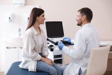 Photo of Sonographer consulting woman before her ultrasound examination in clinic