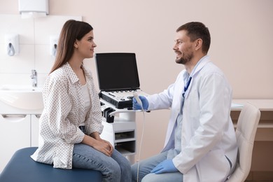 Photo of Sonographer consulting woman before her ultrasound examination in clinic