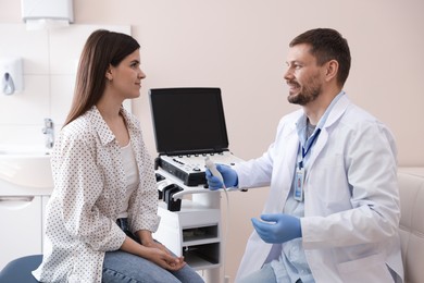 Photo of Sonographer consulting woman before her ultrasound examination in clinic