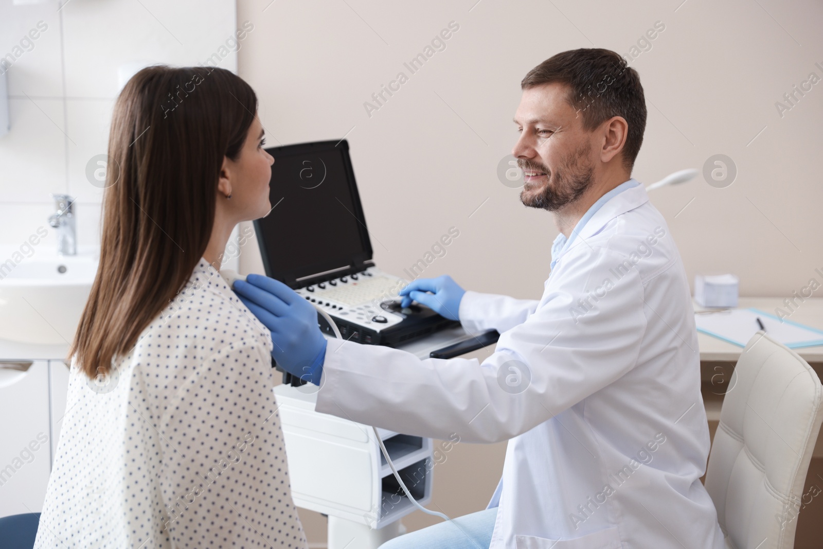 Sonographer conducting woman's ultrasound examination in clinic Photo of Sonographer conducting woman's ultrasound examination in clinic