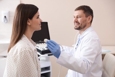 Photo of Sonographer conducting woman's ultrasound examination in clinic