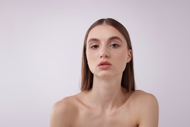 Photo of Portrait of attractive young woman on white background