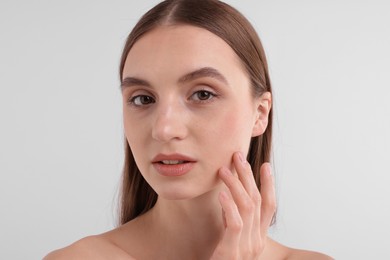 Photo of Portrait of attractive young woman on white background