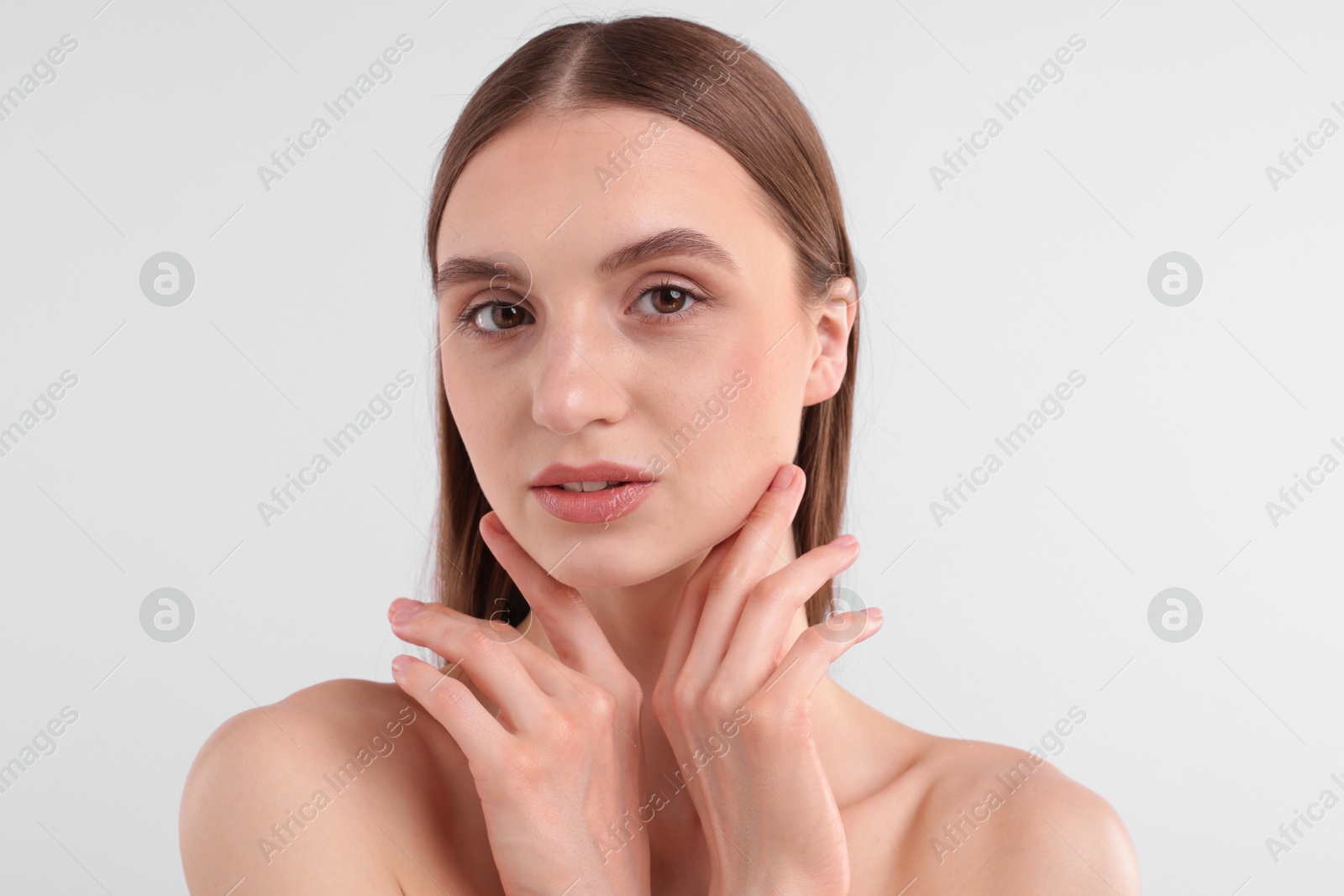 Photo of Portrait of attractive young woman on white background