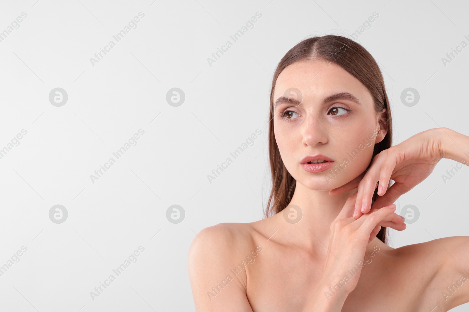 Photo of Portrait of attractive young woman on white background. Space for text