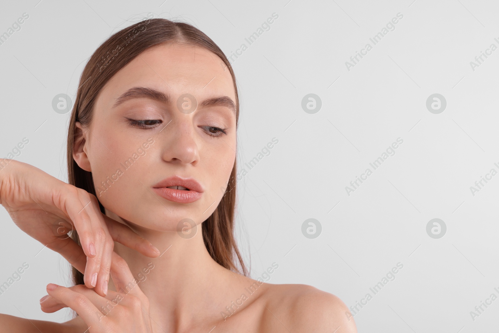 Photo of Portrait of attractive young woman on white background. Space for text