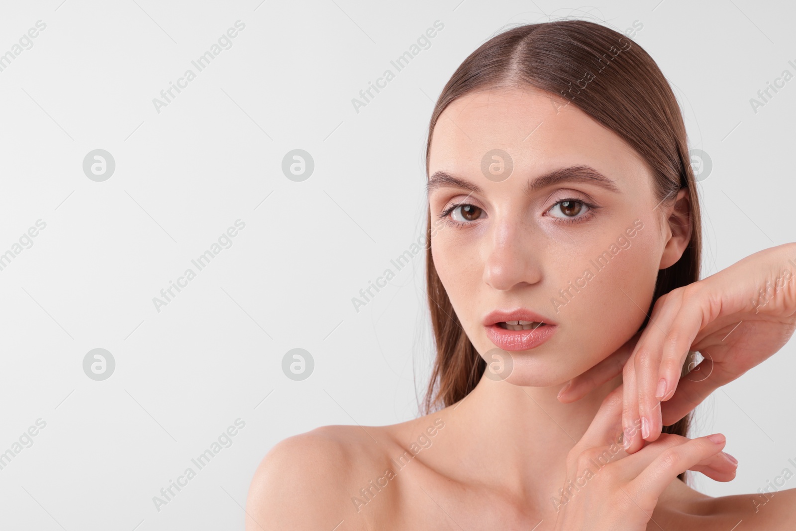 Photo of Portrait of attractive young woman on white background. Space for text