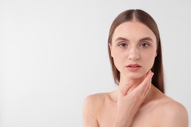 Photo of Portrait of attractive young woman on white background. Space for text