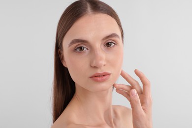 Photo of Portrait of attractive young woman on white background