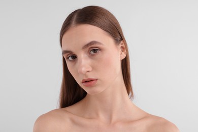 Photo of Portrait of attractive young woman on white background