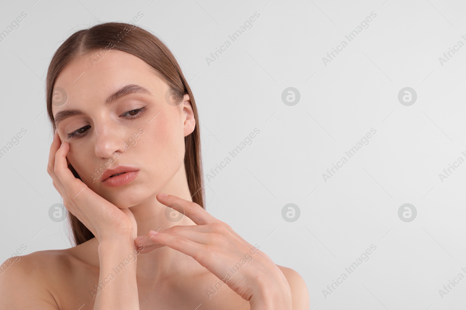 Photo of Portrait of attractive young woman on white background. Space for text