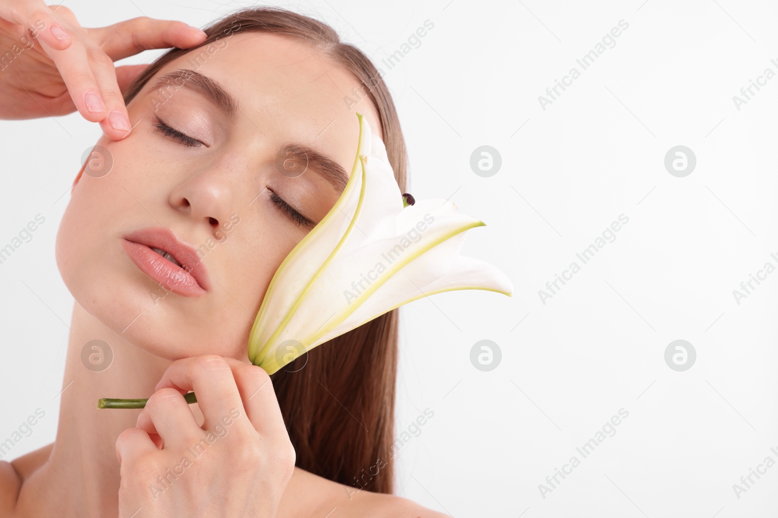 Portrait of attractive young woman with flower on white background. Space for text Photo of Portrait of attractive young woman with flower on white background. Space for text