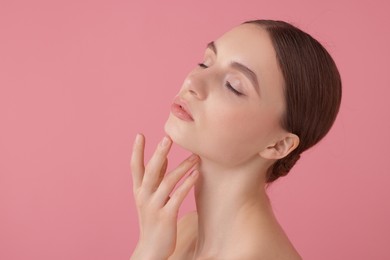 Photo of Portrait of beautiful young woman on pink background. Space for text
