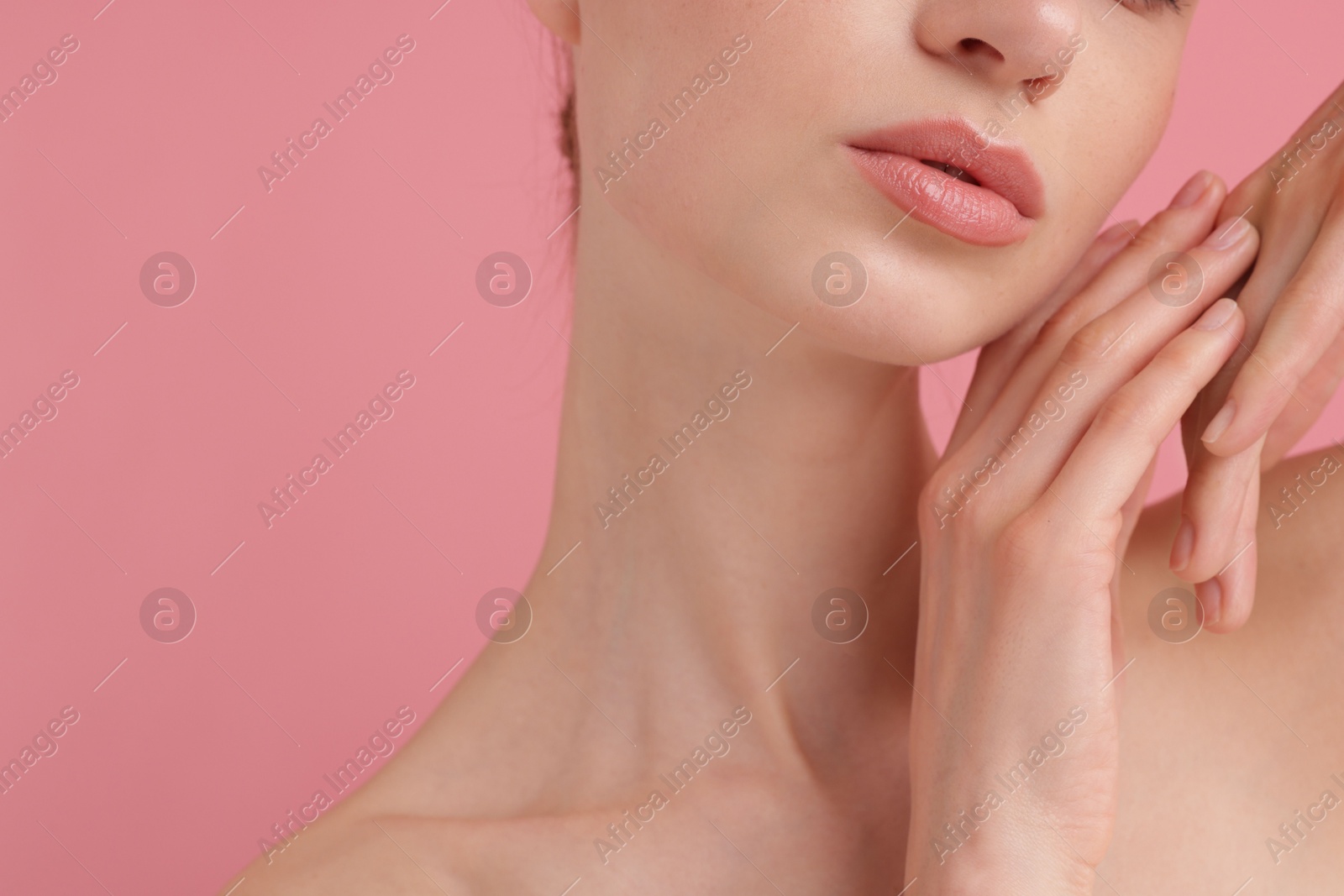 Beautiful woman posing on pink background, closeup Photo of Beautiful woman posing on pink background, closeup