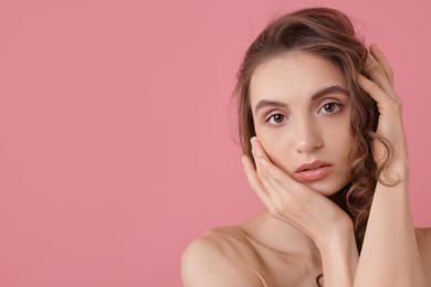 Photo of Portrait of beautiful young woman on pink background. Space for text