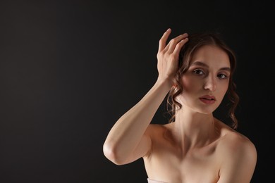 Photo of Portrait of gorgeous young woman on black background. Space for text