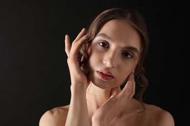 Photo of Portrait of gorgeous young woman on black background