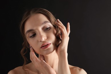 Photo of Portrait of gorgeous young woman on black background