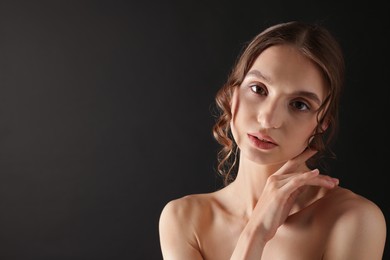 Photo of Portrait of gorgeous young woman on black background. Space for text